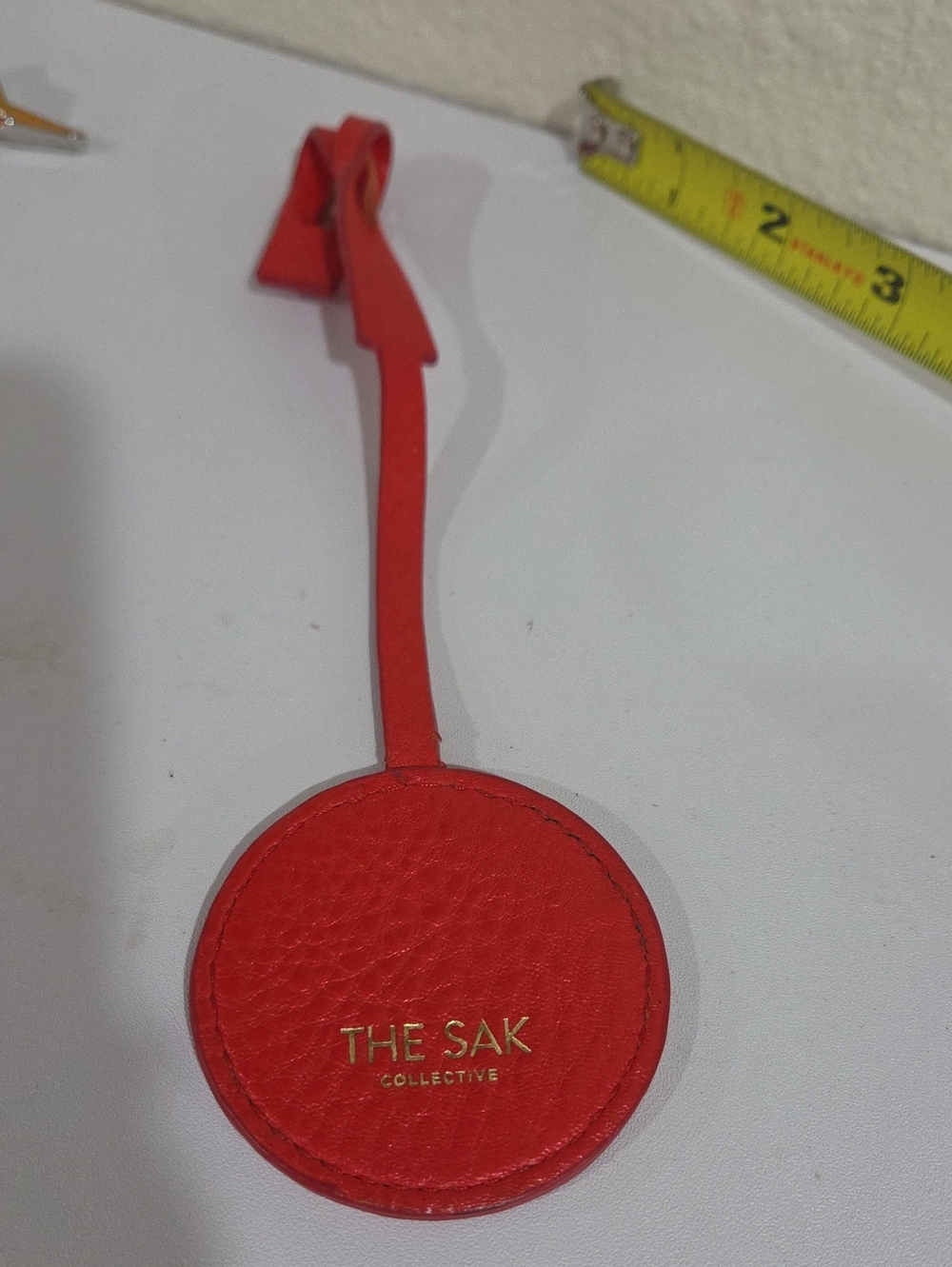 The Sak Red Leather Round Hang Tag